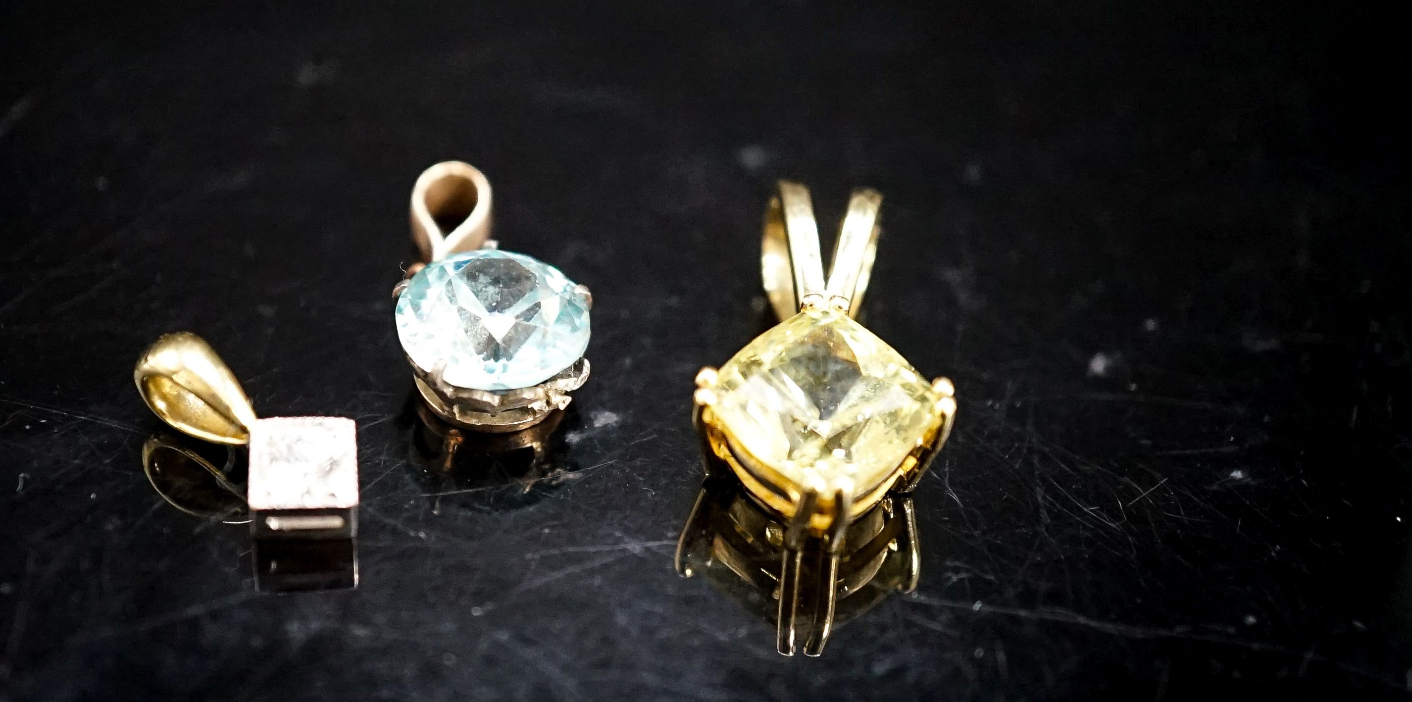 An 18ct and diamond set pendant, overall 14mm and two other gem set pendants, gross 6.5 grams,.